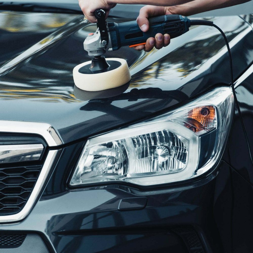 cropped view of car cleaner polishing car with polish machine